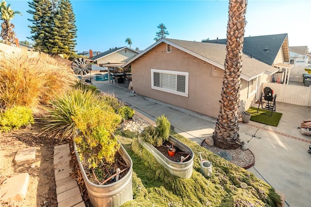 view of side of property featuring a patio area