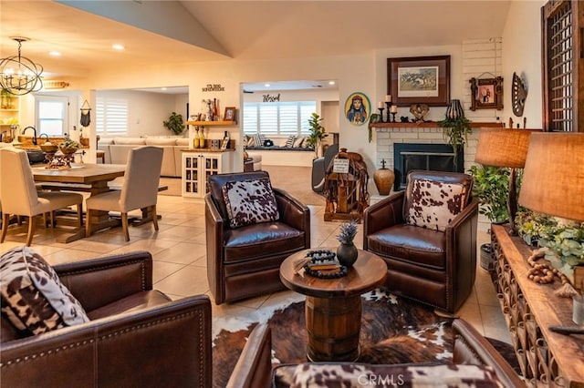 living room featuring a healthy amount of sunlight, vaulted ceiling, a fireplace, and light tile patterned flooring