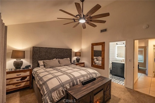 bedroom featuring ceiling fan, ensuite bathroom, carpet floors, and lofted ceiling