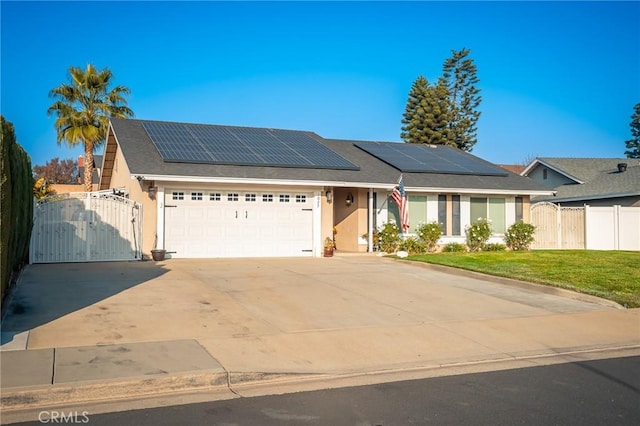 view of front facade with a garage, a front lawn, and solar panels