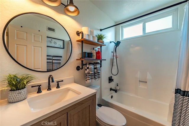 full bathroom with toilet, vanity, and shower / tub combo