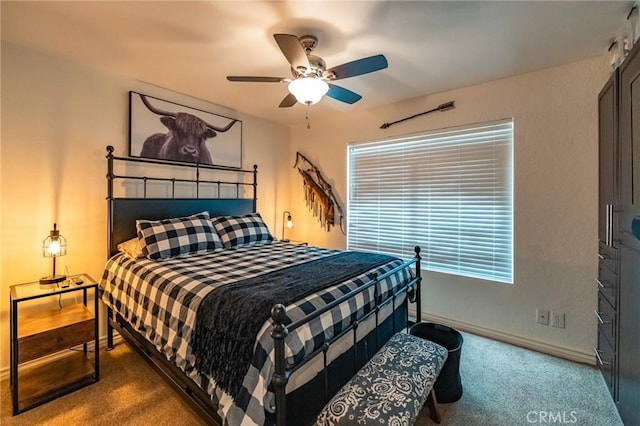 bedroom featuring ceiling fan and carpet