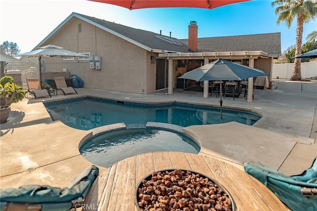 view of pool featuring an in ground hot tub and a patio