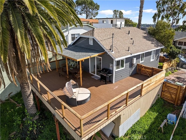 rear view of house with a wooden deck