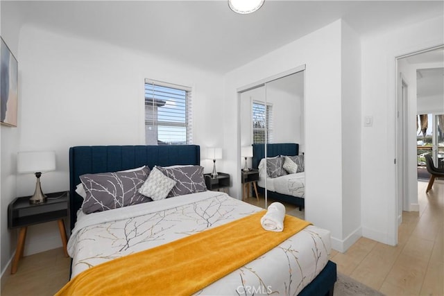 bedroom featuring hardwood / wood-style floors and a closet