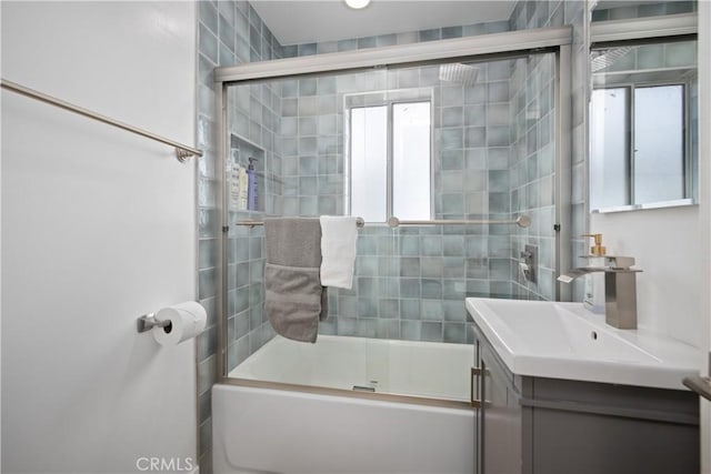 bathroom with combined bath / shower with glass door and vanity