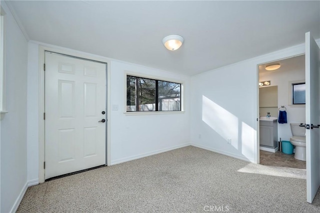 entryway featuring light colored carpet