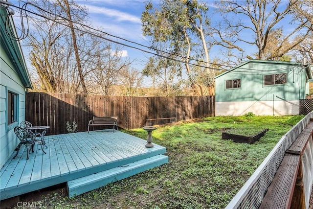 view of yard with a fenced backyard and a wooden deck