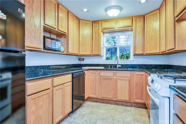 kitchen with black appliances, dark stone counters, and sink