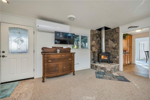 living room with light carpet, crown molding, a wood stove, and a wall mounted air conditioner