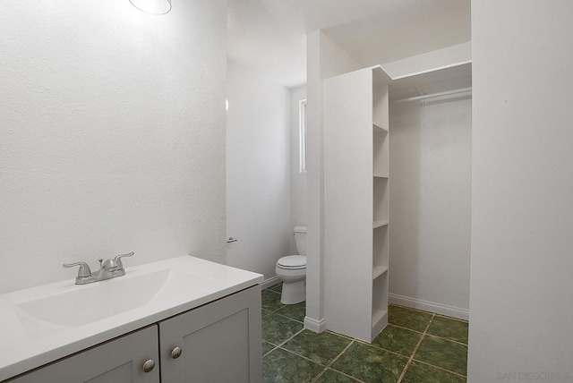 bathroom featuring toilet and vanity