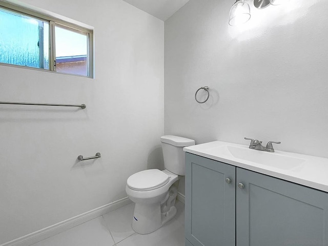 bathroom featuring toilet, vanity, and tile patterned flooring