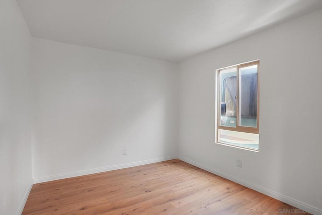 unfurnished room with light wood-type flooring