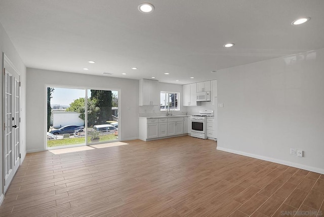 unfurnished living room with sink