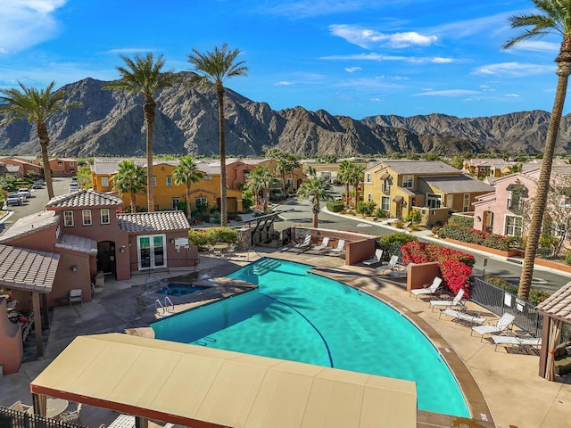 view of pool featuring a mountain view and a patio area