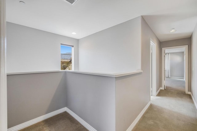 hall featuring light colored carpet