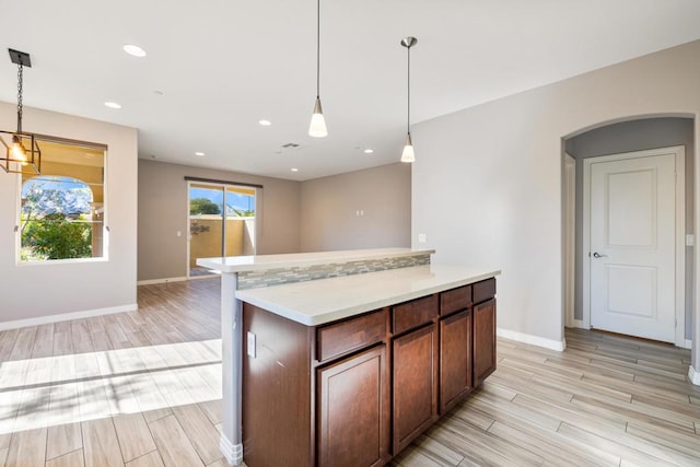 kitchen with a kitchen island and hanging light fixtures