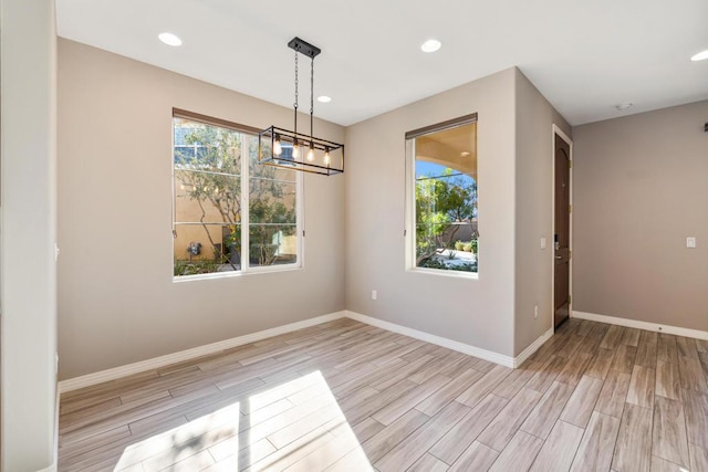 unfurnished dining area featuring light wood-type flooring