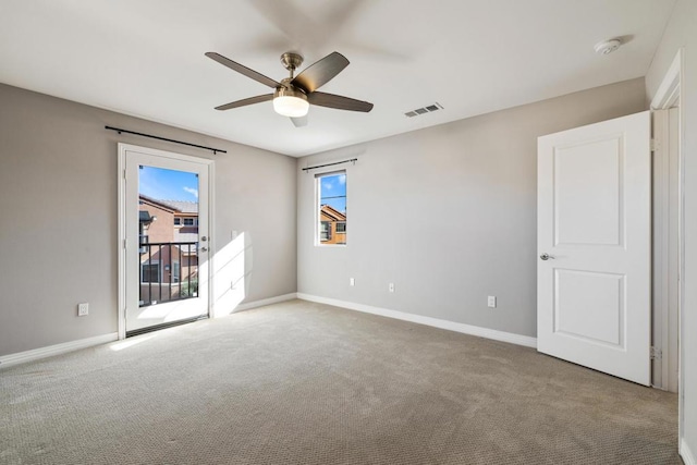 spare room with carpet floors and ceiling fan