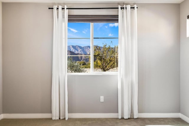 interior space featuring a mountain view and carpet floors