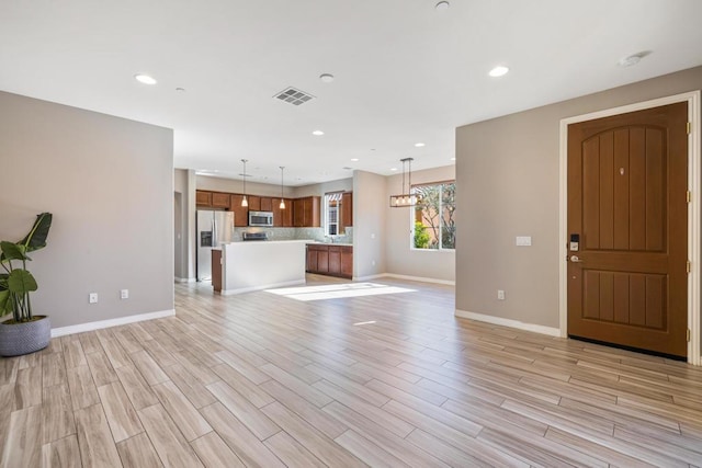 unfurnished living room featuring light wood-type flooring