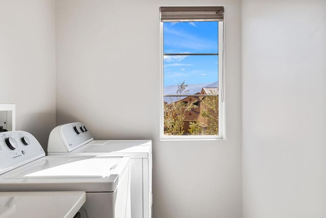 clothes washing area with separate washer and dryer