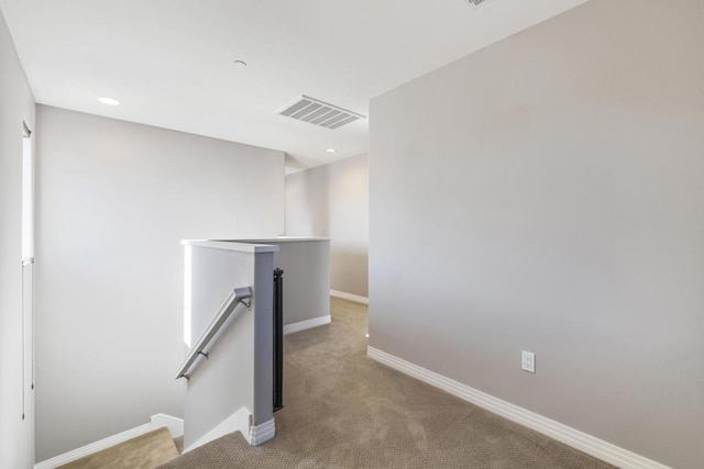 hallway featuring light carpet