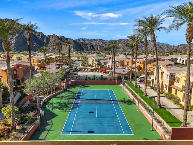 view of tennis court with a mountain view