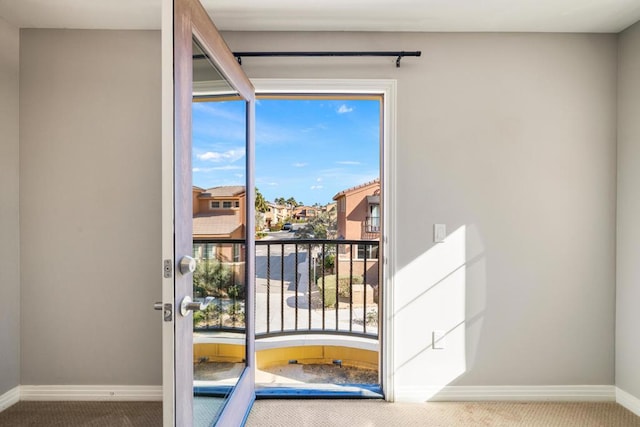 doorway to outside with carpet floors and plenty of natural light