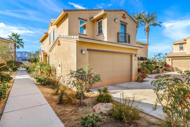 view of front of property with a garage and a mountain view