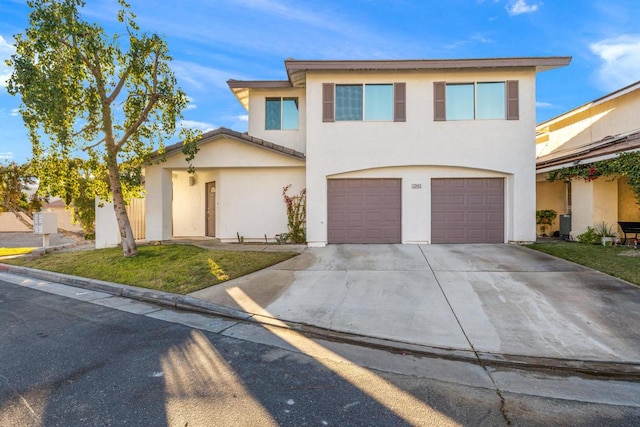 view of front of home featuring a front yard and a garage