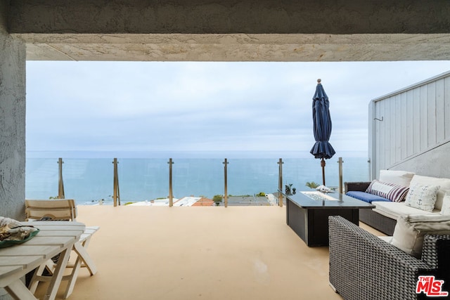 view of patio featuring an outdoor living space and a water view