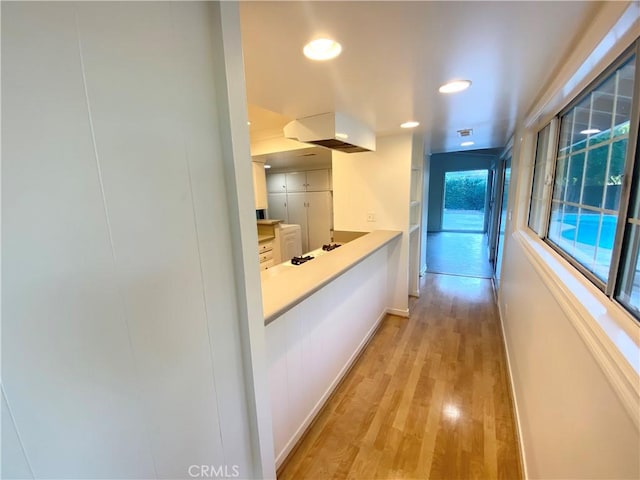 corridor featuring light hardwood / wood-style floors