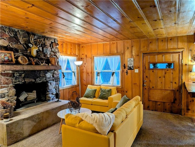 living room with carpet, wood ceiling, a fireplace, and wooden walls