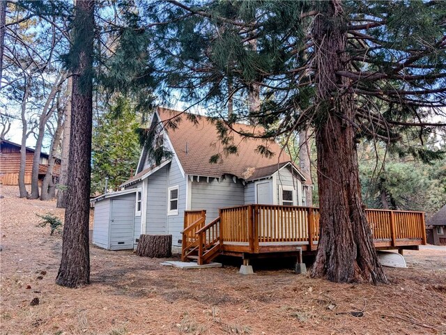 back of house with a deck