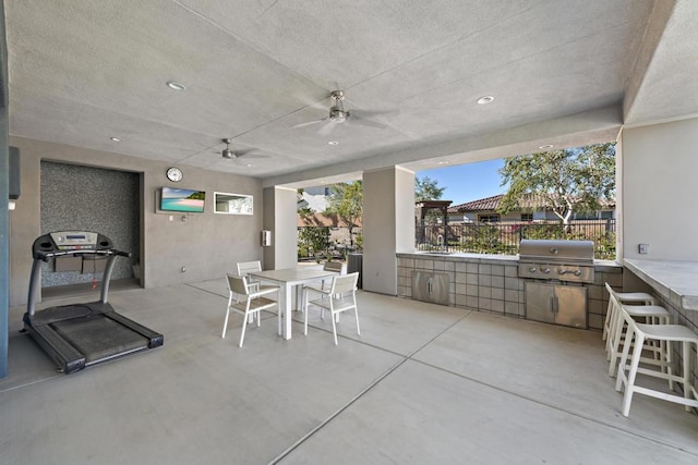 view of patio featuring a grill, area for grilling, and exterior bar