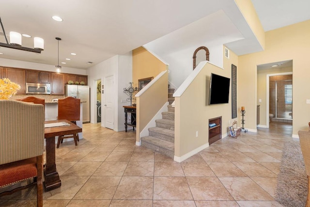 interior space featuring light tile patterned floors and washer / dryer