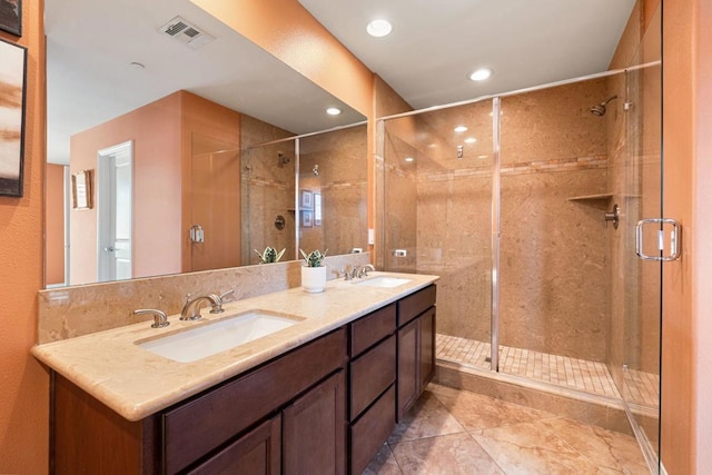 bathroom featuring vanity, tile patterned flooring, and a shower with door