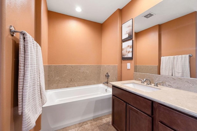 bathroom featuring a bath, tile patterned flooring, and vanity