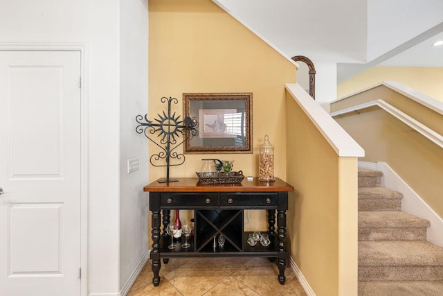 stairway featuring tile patterned flooring