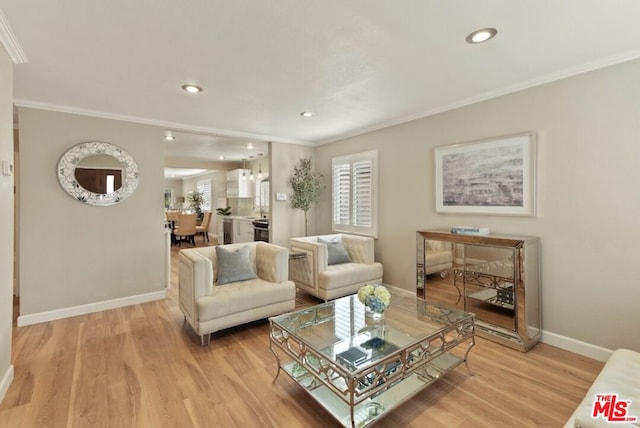 living room with ornamental molding and light wood-type flooring