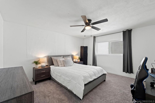 bedroom with ceiling fan, carpet, and a textured ceiling