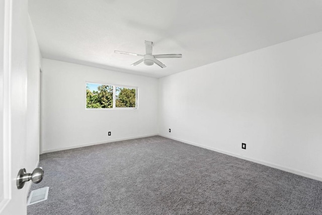 empty room with ceiling fan and carpet flooring