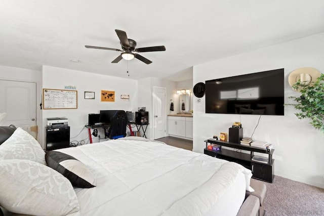 carpeted bedroom with ceiling fan and ensuite bath