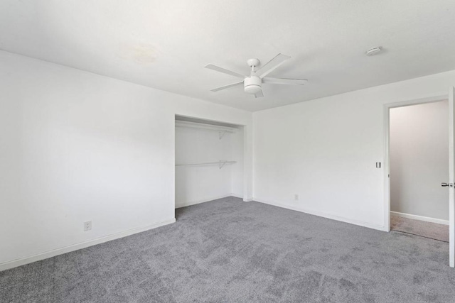 unfurnished bedroom featuring ceiling fan, a closet, and carpet flooring