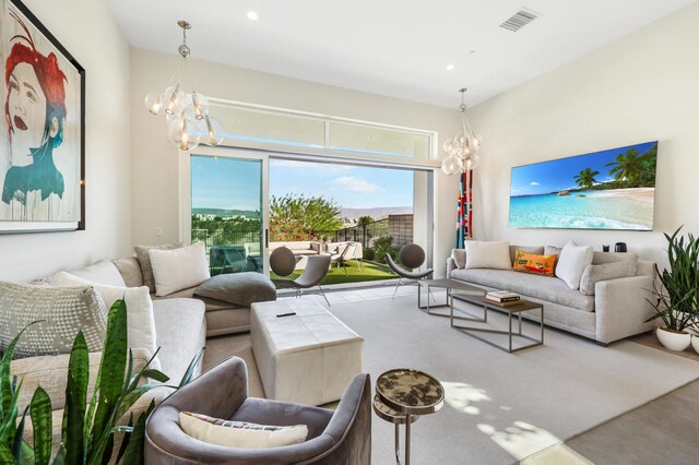 living room with concrete flooring and a chandelier