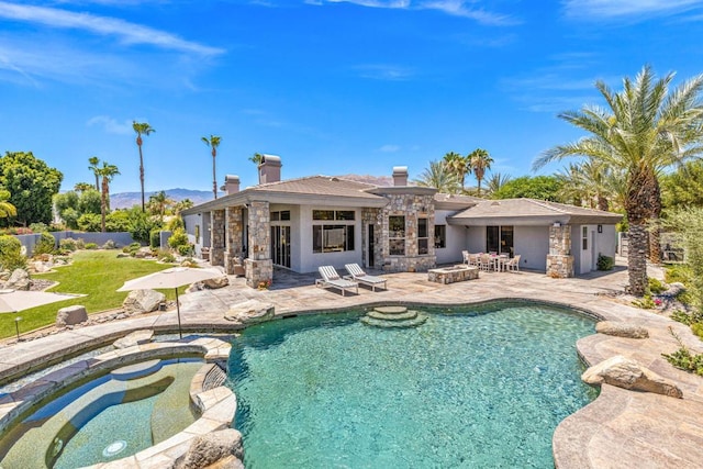 view of swimming pool featuring a patio and an in ground hot tub