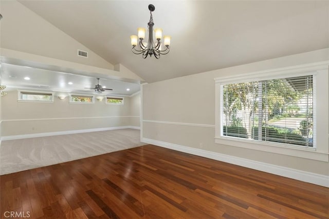 unfurnished dining area featuring lofted ceiling, hardwood / wood-style flooring, and ceiling fan with notable chandelier