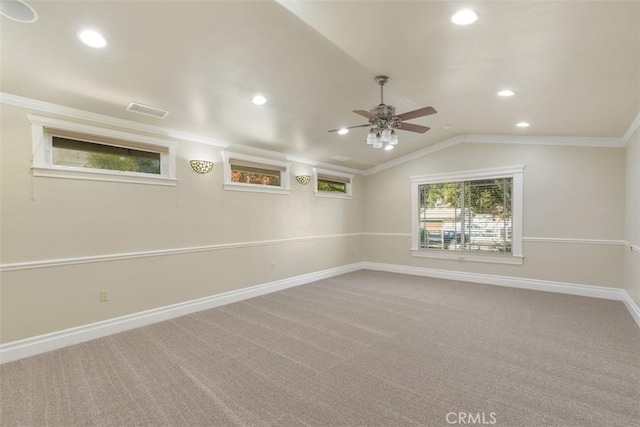 carpeted empty room featuring lofted ceiling, crown molding, and ceiling fan