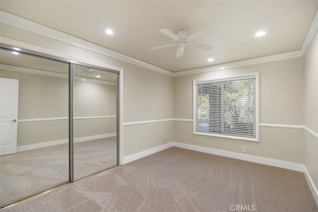 unfurnished bedroom with light colored carpet, ornamental molding, a closet, and ceiling fan